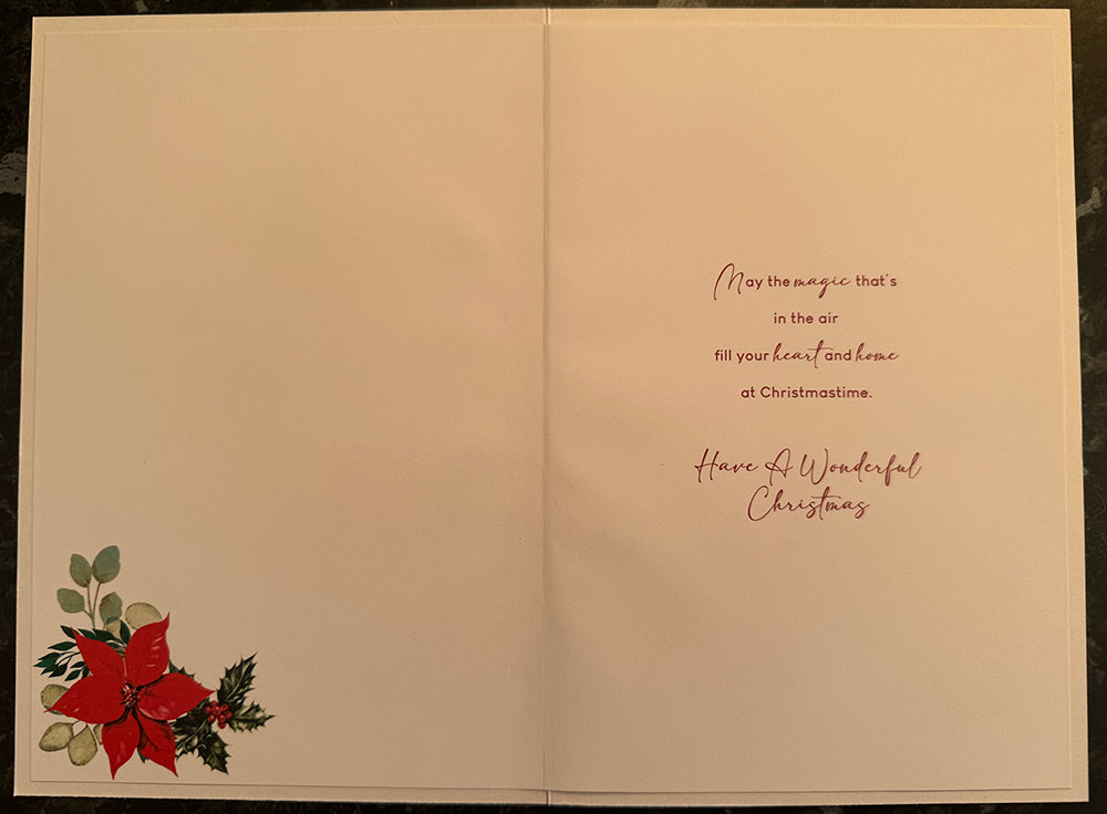Inside of friend Christmas card with poinsettia decoration and verse wishing joy, heart and home at Christmastime